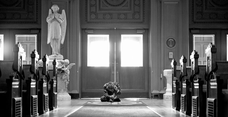 A homeless man's humbled, prostrated prayer inside Saint Ignatius Church in San Francisco. © 2014 Thorsten Overgaard. Leica M 240 with Leica 50mm Noctilux-M ASPH f/0.95