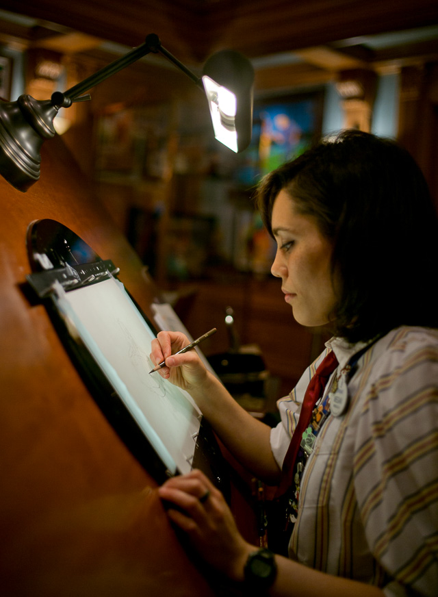 Megan Matsumoto working by the drawing tabe in Walt Disney's original office in Disneyworld