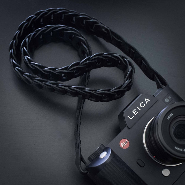 The ROCK'N'ROLL (formerly known as TIE HER UP) "Rock'n'Roll Chain SL" black leather strap for the Leica SL that comes in 100cm and 125cm length. I recommend the 125cm, or ask for special lenght that fits you. Price around $150. 