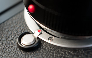 Bayonet lock and red dot

There is a bayonet un-lock button on the Leica 9 that is pressed to release the lens. 

When you put on a lens, the red dot on the lens has to be on top of the bayonet lock, then when you turn the lens clockwise it locks.

You can see the lock (with a small red dot) on the bayonet here.