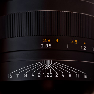 The many lines "meeting in the center" shows how deep a field will be in "acceptable focus" at any given f-stop and distance.   At closest distance, the 1.25 lines shows that basically a hair-line will be in focus at f/1.25.  At closest distance, if the aperture is set to f/16, the area from 75cm - 90cm would be in focus. As the subject in focus is further away, a greater depth of the field would be in focus: If you look at the picture above, at f/16, everything from 10 meters to infinity would be in focus. In other words, the closer you move to a subject, the more critical (thin) becomes the focus. You want the background more blurred? Go closer!  By the way, the ∞ symbol is infinity. If you stop down the lens to f/16, the midst of the ∞ symbol would be above the f/16 line (which would make the distance from 4 meters to infinity in focus). Take a lens and play with the depth of field scale to grasp it easily.  "Acceptable focus" is a term from the film days and basically means this area will look really sharp.  