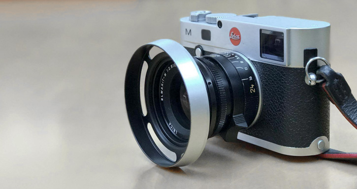 The new current Leica 35mm Summicron (model 11673 and 11674) with my ventilated lens shade model #3520-OUS that sits on the ouside thread of the lens. To the left is the Leica model #12473 square shade that the lens comes with.