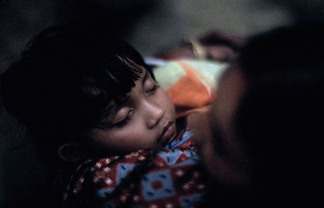 A child sleeping with his mother (Kolkata, India).