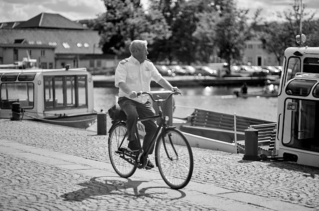 The captain of the Hjejlen sight-seeing boat in Silkeborg leaving after a days work. Leica M10-R with Leica 75mm Summilux-M f/1.4. © Thorsten Overgaard.