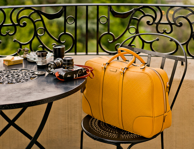 The Italian GUCCI camera bag (2014), aka the leather duffle travel bag in Bright Diamante yellow color. A perfect travel bag with a Billingham insert for the camera, lenses and accessories such as hard drives, lightmeter, batteries, etc. Larger than the Louis Vuitton iCare and the Goyard Ambassade, yet it looks quite compact. $1,850 with shoulder strap in matching yellow leather (model 353394 AIZ1G 7011) and also comes in blue, red and black. 