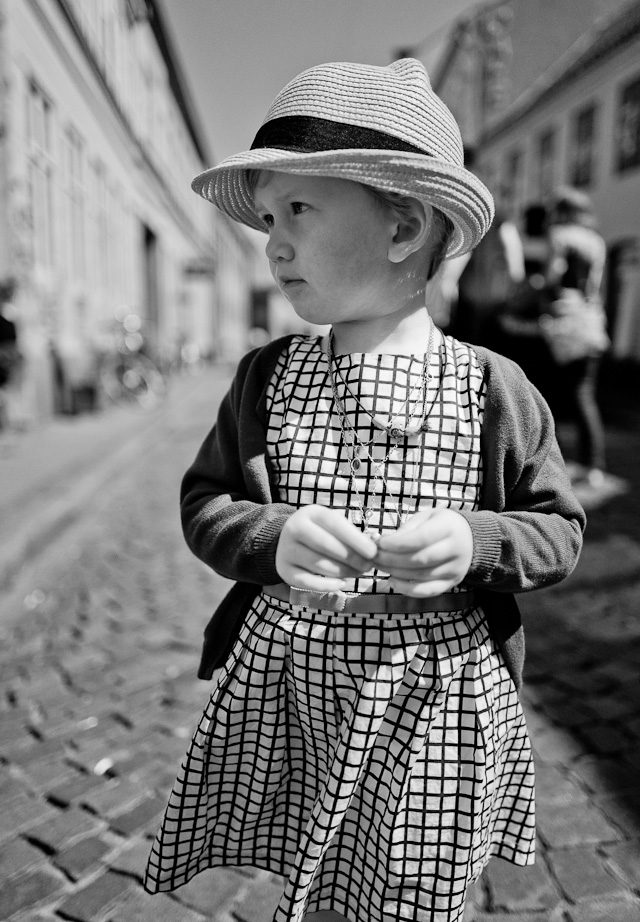 Young lady attending a wedding in Aarhus, Denmark. Leica Q with Leica 28mm Summilux-Q ASPH f/1.7. (800 ISO, 1/6400, f/1.7 with B+W 3-stop ND filter. Converted to monochrom in Lightroom from the DNG file.). 
© 2015 Thorsten Overgaard.