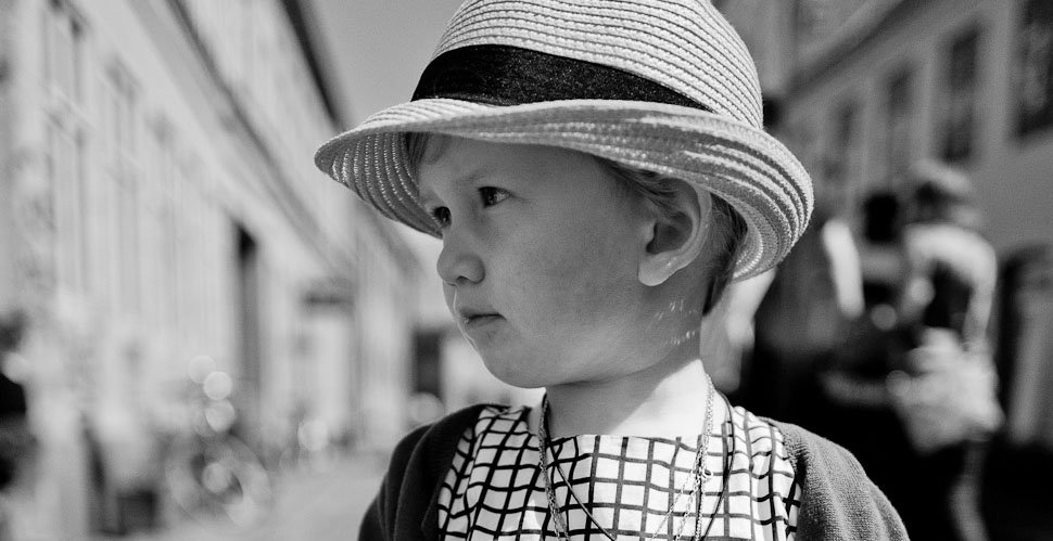 Young lady attending a wedding in Aarhus, Denmark. Leica Q with Leica 28mm Summilux-Q ASPH f/1.7. (800 ISO, 1/6400, f/1.7 with B+W 3-stop ND filter. Converted to monochrom in Lightroom from the DNG file). 
© Thorsten Overgaard.