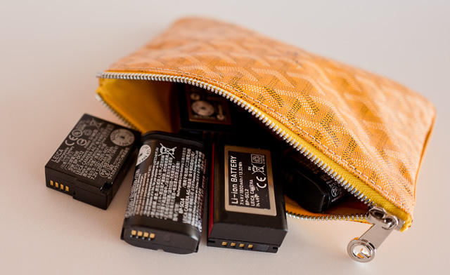 I have my spare batteries for my cameras inside a fairly thich Goyard canvas pouch and no other items of metal that could make the metal parts of the batteries come into contact with each others. 