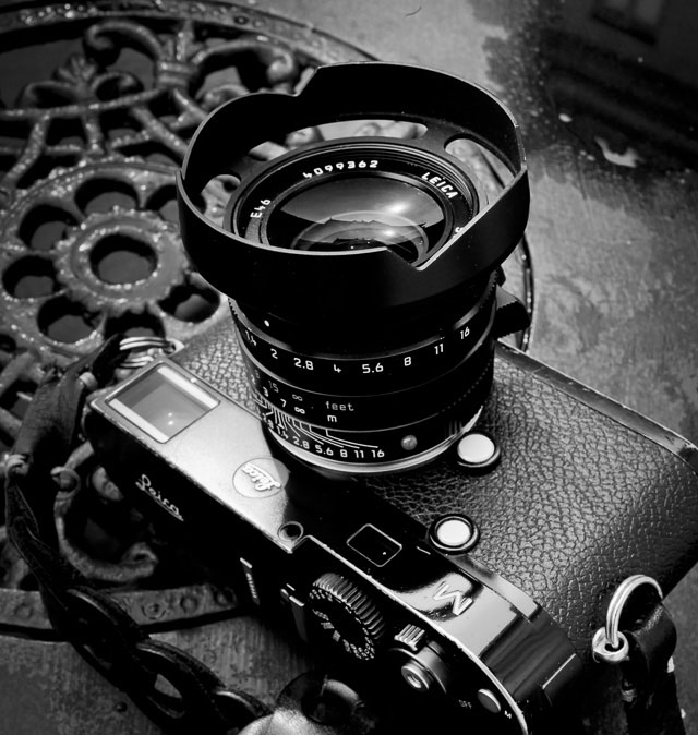 My Leica M with Leica 35mm Summilux-M ASPH f/1.4 FLE and the ventilated lens shade and Tie Her Up Rock'n'Roll strap. The ventilated lens shade goes on the outside screw of the lens, leaving the filter screw for filters. You can buy the lens shade in Black Paint ($129) and soon also in Silver ($149) on this page. 