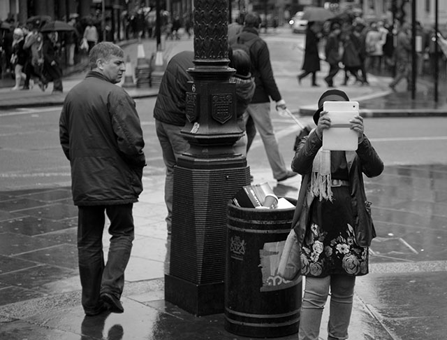 A woman in London photographing with her iPad. © Thorsten Overgaard. 