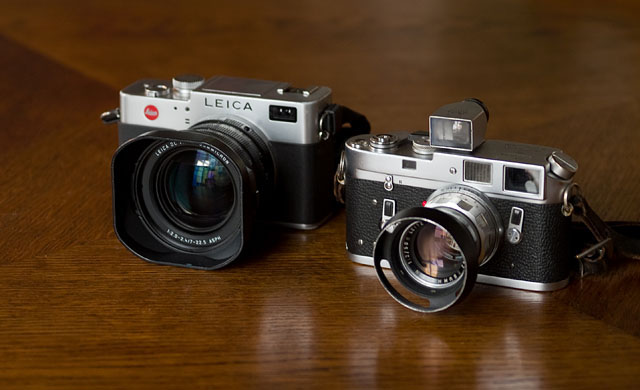 To the right is the Leica M4 film rangefinder from 1966 with the "real" rangefinder mechanism. To the left is the Leica Digilux 2 "digital rangefinder" from 2006 that has no direct view through a viewfinder. Where the viewfinder traditionally sits, there is an electronic "eye" for the auto focus, and from the other side the user looks through a small (electronic) viewfinder and sees a digital preview of what the camera's sensor sees.