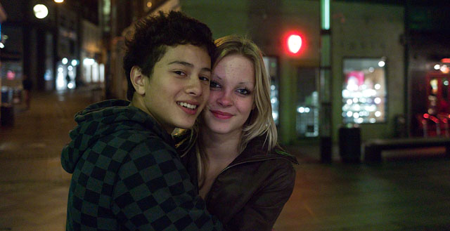 A final one with skin tones, but in a very mixed light (yellow street light from above, halogen light from a store window behind the photographer , tube street lamps to both sides). Leica M9 at 1250 ISO, 1/30 second, 35mm Summicron-M f/2.0. And here is a 100% crop: