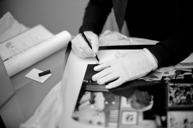 Thorsten Overgaard signing prints in Leiac Galerie Salzburg. Leica M9 with Leica 50mm Noctilux f/1.0. ©Lisa Kutzelnig. 