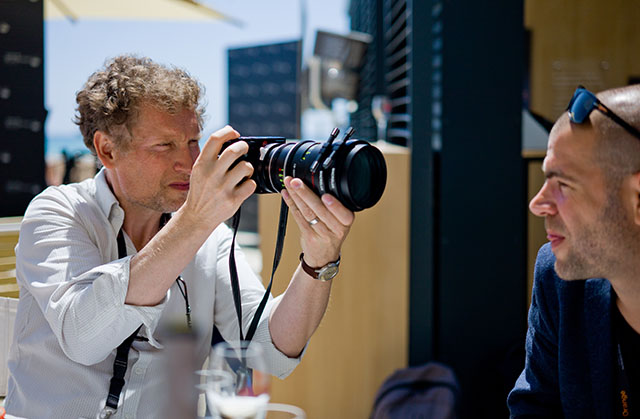 Cinematographer Guillamue Deffontaines using a 100mm Leitz Cine f/1.4 lens on a Leica M still camera at Cannes Film Festival. © Thorsten Overgaard. 