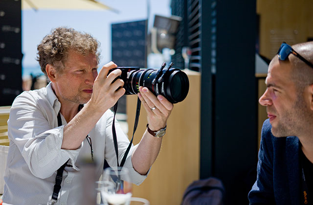 Cinematographer Guillamue Deffontaines using a 100mm Leitz Cine f/1.4 lens on a Leica M still camera at Cannes Film Festival. © Thorsten Overgaard.