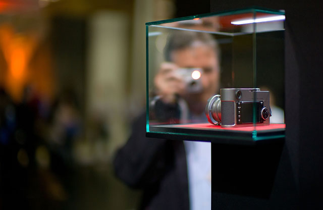 Visitors at Leica Camera AG at Photokina 2010 admires the Leica M9 titanium. Photo: Thorsten Overgaard. 