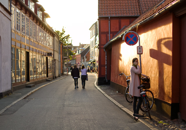 Perspective is relative position and distance. As here where the girl in front is more than two times taller than the peoplle walking, and 8 times taller than the people in the far background. Also, the parts of the buildings closer to the viewer are "taller" than the parts of the same building further away. Late afternoon sun in Denmark. Leica TL2 with Leica 35mm Summilux-TL ASPH f/1.4. © 2017 Thorsten Overgaard.