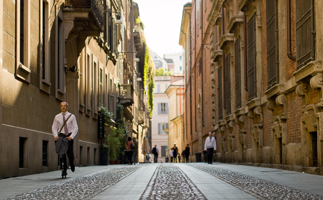 Scooting to work in a big, big world. (Via Fiori Oscuri in Milano). Leica TL2 with Leica 50mm Summilux-M ASPH f/1.4 Black Chrome. © 2017 Thorsten Overgaard.