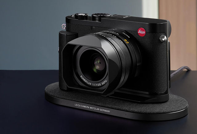 The Leica Q3 with handgrib and on the wireless charger. 