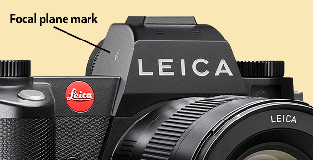 The Leica SL3 has a focal plane mark, which marks where the sensor plane is so that one can measure the distance from focal plane to subject with a measurement tape (and set the focus on the lens accordingly). This is how it is done in movies where almost all cameras are manual focusing. © Thorsten Overgaard. 