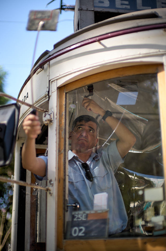 The tramp driver in Lisbon changes the sign on the roof using a mirror before he heads out on the route. Leica M11 with Leica 50mm Noctilux f/0.95 FLE. © Thorsten Overgaard. 

