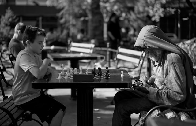 Kid wants to play chess, old man wants to play with his smartphone. Washington Park. Leica M10-P with Leica 50mm Summilux-M ASPH f/1.4. © Thorsten Overgaard. 