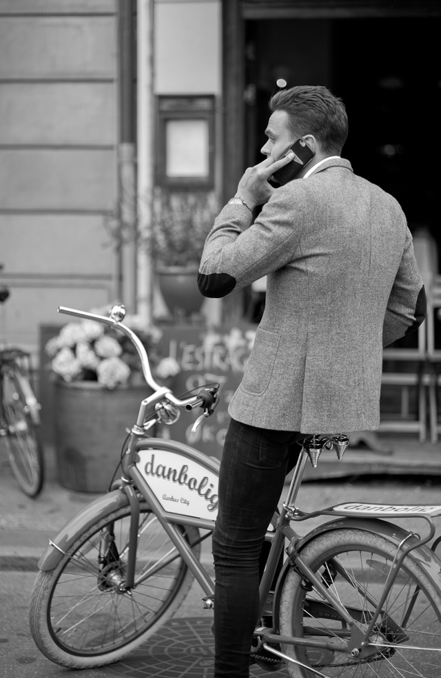 A real estate manager on his bicycle in my hometown Aarhus, Denmark. Leica M 246 Monochrom with Leica 75mm Summilux-M f/1.4. © 2015 Thorsten Overgaard.