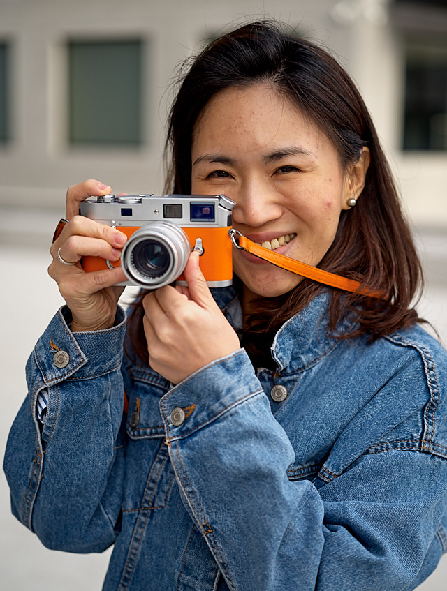 Kullaya Souvanheuane in Wetzlar with her orange Leica M7 Hermes edition. Leica M10-P with Leica 50mm APO-Summicronn-M ASPH f/2.0 LHSA. © Thorsten Overgaard. 