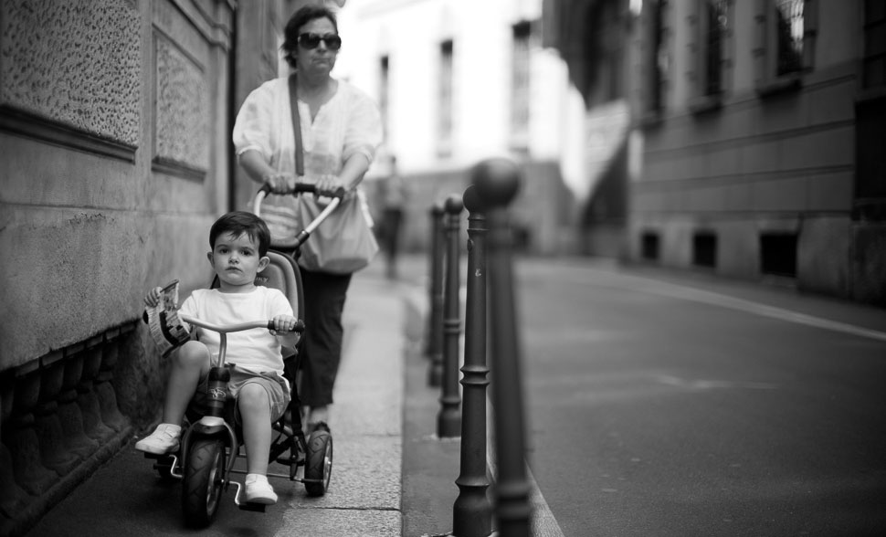 It is not uncommon for boys and men to live with their family into their 30's. In this photo I feel I captured that spirit. This boy is not going anywhwere soon without his mama. Leica M10 with Leica 50mm Noctilux-M ASPH f/0.95. © Thorsten Overgaard