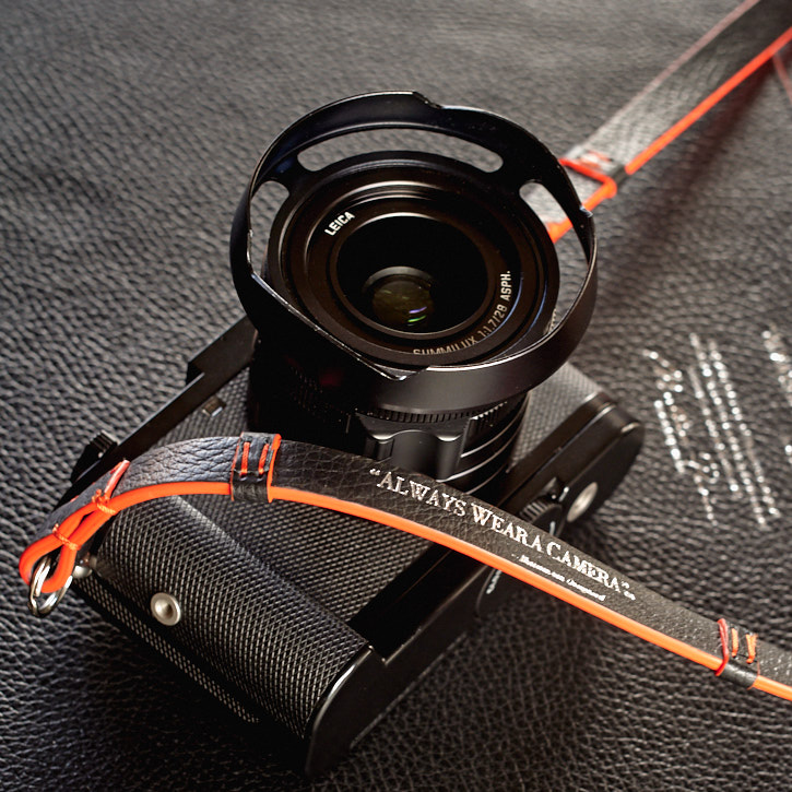 The Leica Q (2015) with Leica handgrip and "Always Wear a Camera" leather strap and "Always Wear a Camera" ventilated shade. © Thorsten Overgaard.