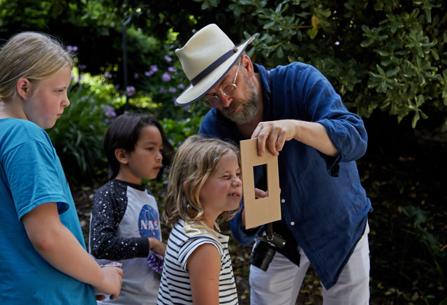 Teaching the next generation: Photography is simple. You must look to observe, decide on a photo you will take, then take it. Most people struggle with observing and deciding, simply just letting a camera take random photos. Photo by Mike Jones. 