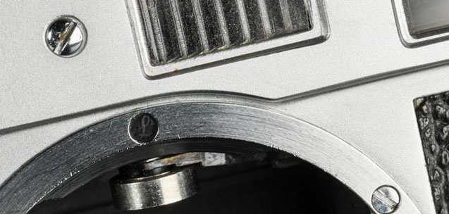 A Leica with a small "L" impressed in wax over the fifth screw of the M bayonet.