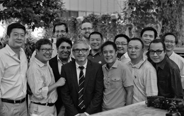 One of the rare occasions where Peter Karbe was outside his office: October 2013 with hard-core fans in Singapore who also got him to sign his lenses. Photo by Ronald Yeoh. 