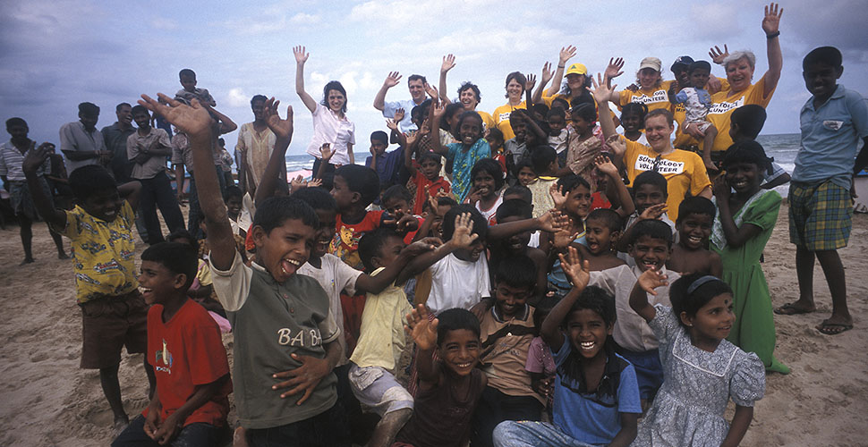 The fishermens kids on the beach in front of Trinomalee in Sri Lanka where the fishermens families live in temporarily tents and cottages after the tsunami hot on 26 December 2004. Many of the kids are were afraid of the ocean, because of what happened the 26th December. The volunteers worked with the kids for the day, helping the kids get in contact with the ocean again gradually. First the kids help clean up the beach areas for stuff left after the tsunami so that the beaches are nice again. Then then play games on the beach with the volunteers. Also the kids draw their concept of the ocean to enable them to communicate what they think of the ocean. Finally the day ends with all the volunteers and all the kids walk out in the ocean and back again a few times till all kids are happy and feel good about the ocean again. Group photo by the end of the day. Leica M4 with Leica 21mm f/3.4. © Thorsten Overgaard. 